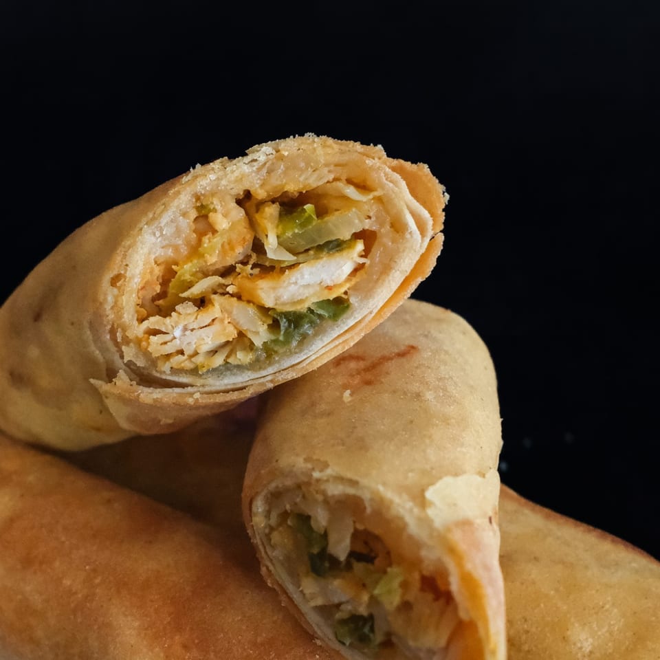 Golden fried rolls cut open to reveal their filling.